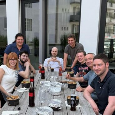Some of our team members at a Pizza Day in the Cologne office during summer 2025
